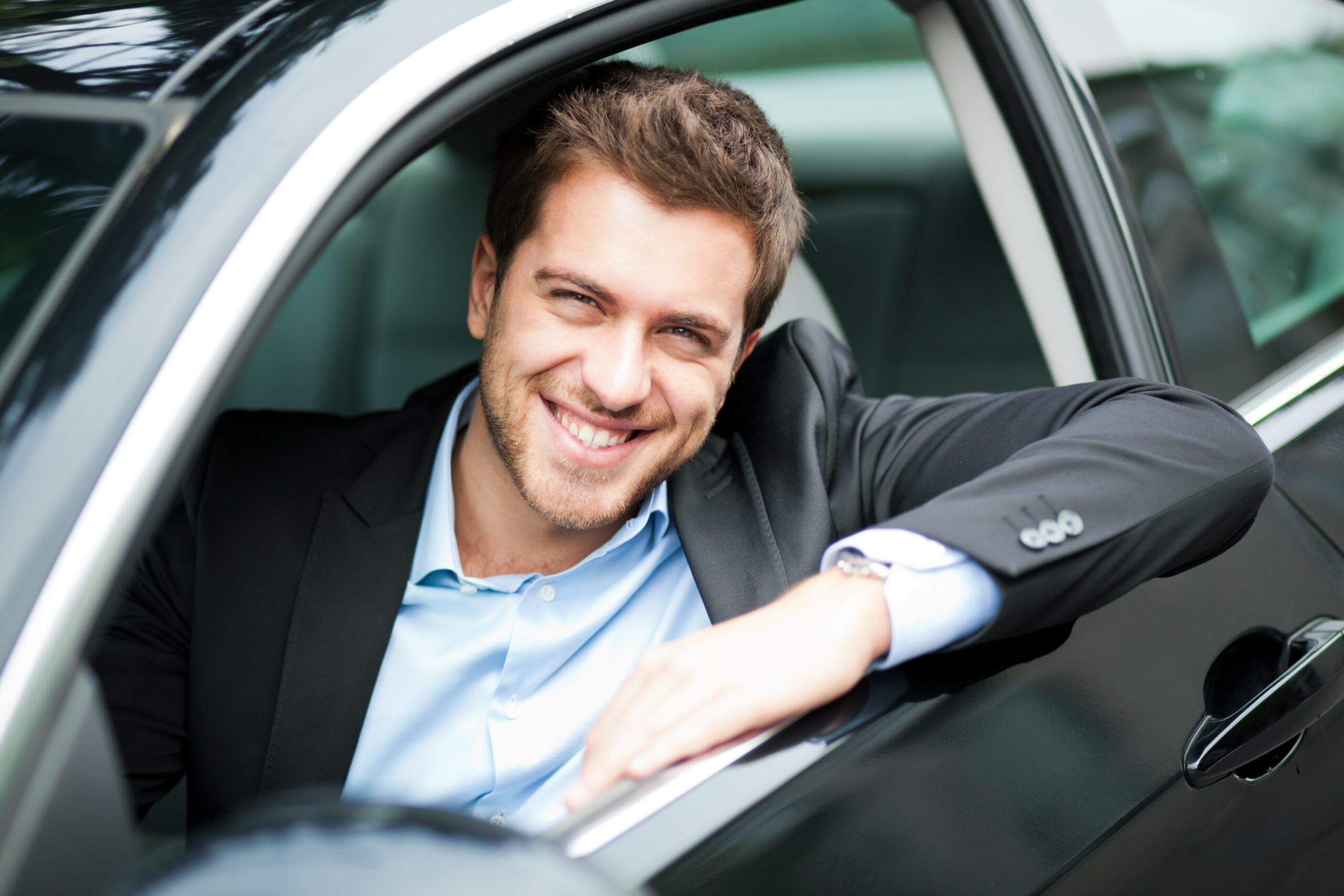 Young Man Sitting in a Car